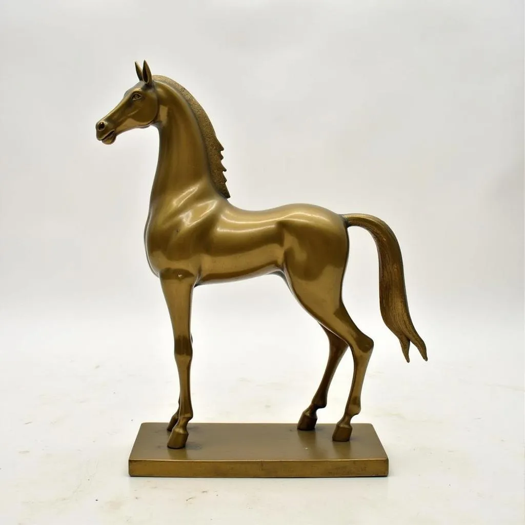 A modern, abstract design brass horse statue