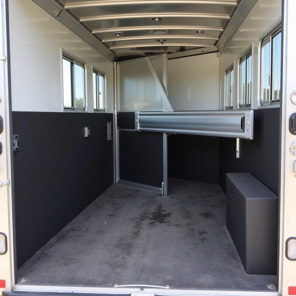 Interior of a horse trailer showing the stalls, mats, and ventilation